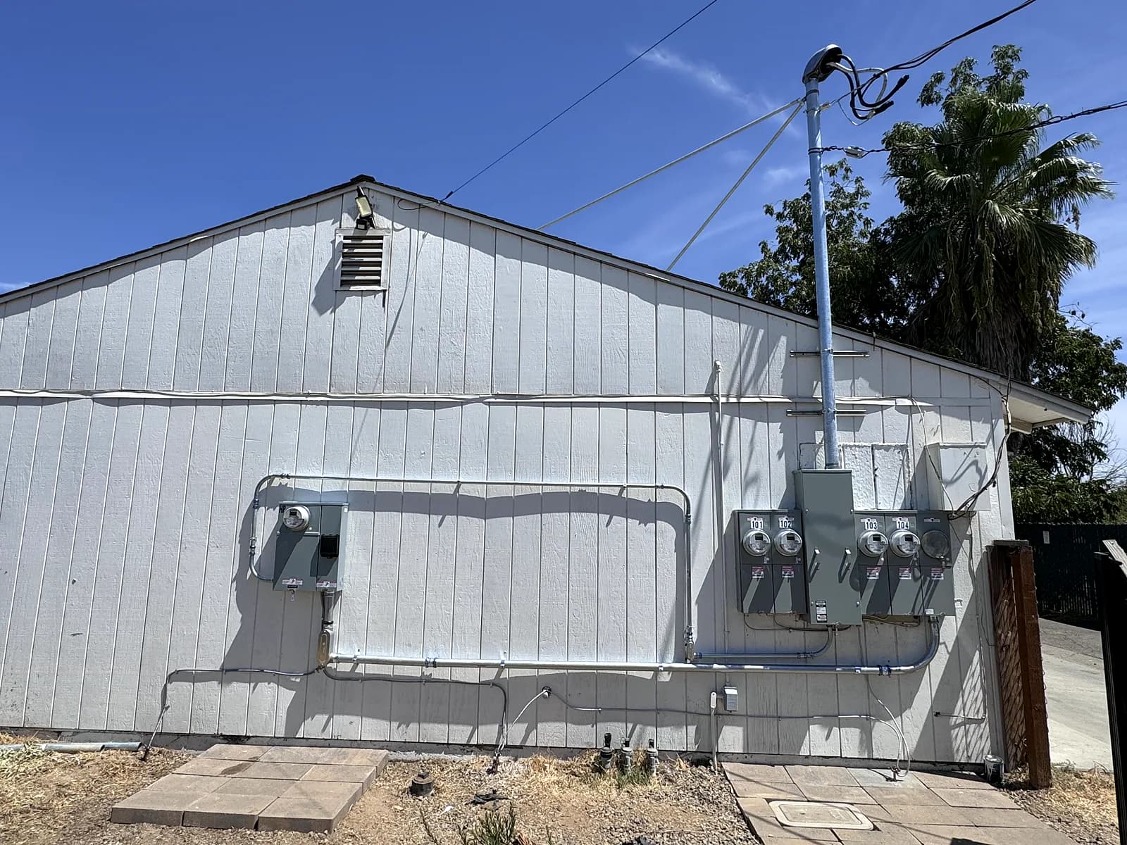 A building with a new 400 amp five-meter main panel installed on its side wall